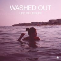 Iconic cover art of Washed Out's Life of Leisure, featuring a girl in the water under a pink sunset sky.